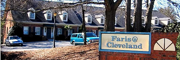 The image shows a sign with the name  Paris Cleveland  on a brick wall, indicating the name of a residential area or community.